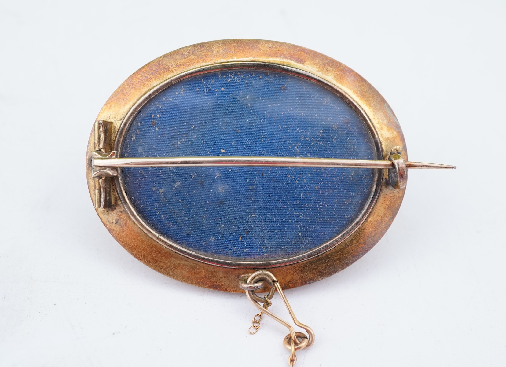 A group of gilt metal/pinchbeck jewels, 19th and early 20th century, comprising: a brooch of knotted design; two gate bracelets; a fancy link bracelet; an open-faced pocket watch; two oval panel brooches, and two watch c